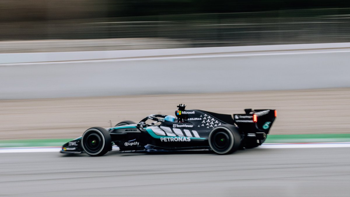 Side view of the 2026 Mercedes Formula 1 car driving at speed during the private shakedown test in Barcelona.