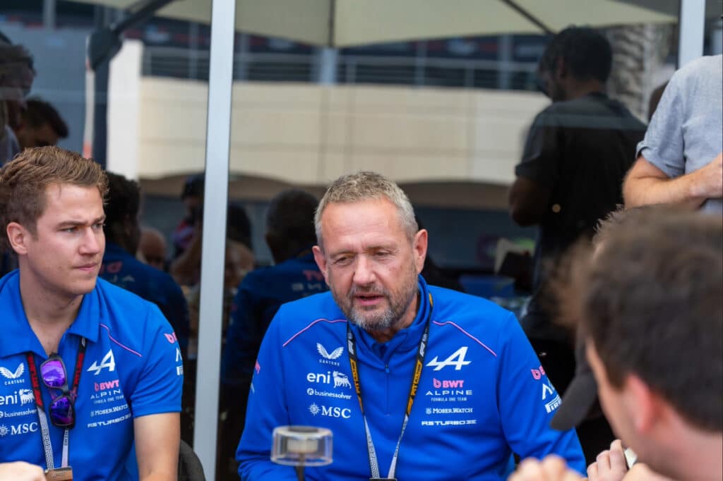 Members of the Alpine F1 Team leadership in a technical briefing during 2026 pre-season testing, representing organizational stability.