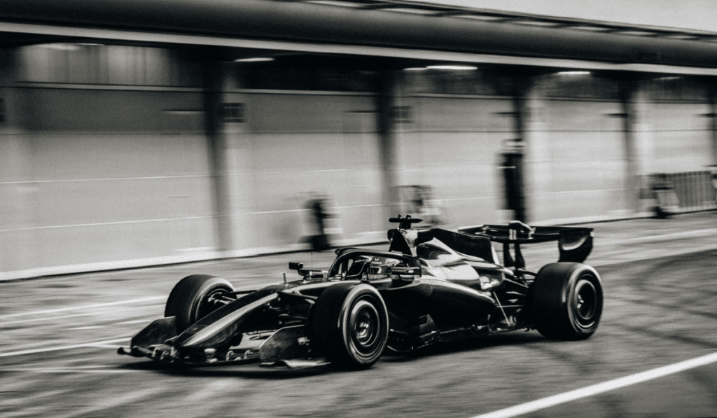 The Aston Martin AMR26 in all-black carbon-fiber camouflage livery during 2026 winter testing in Barcelona.