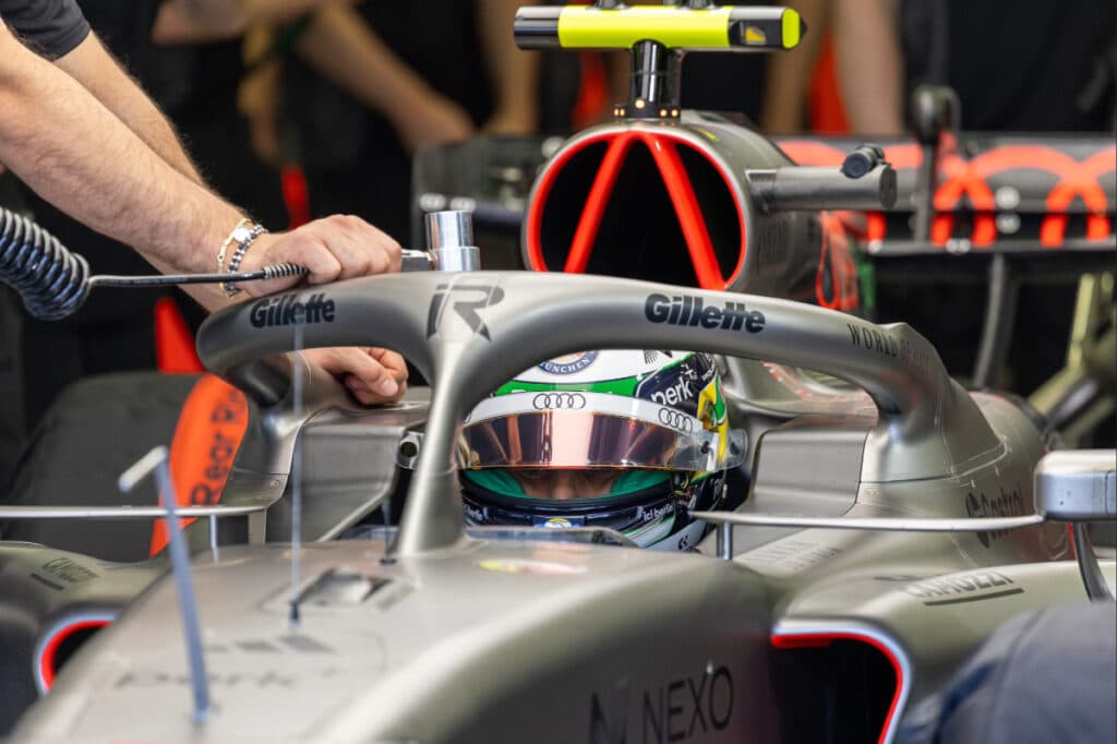 Audi F1 Team mechanics performing technical checks on the car's structural components during 2026 testing.