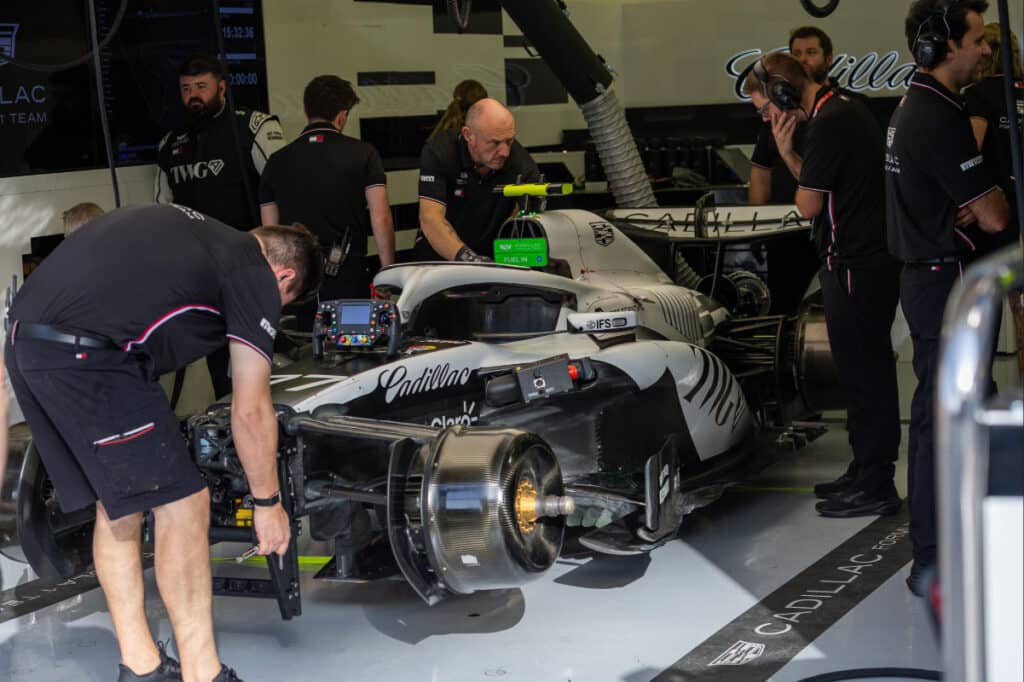 Cadillac F1 Team mechanics working on the 2026 car in the Bahrain pit garage during testing.