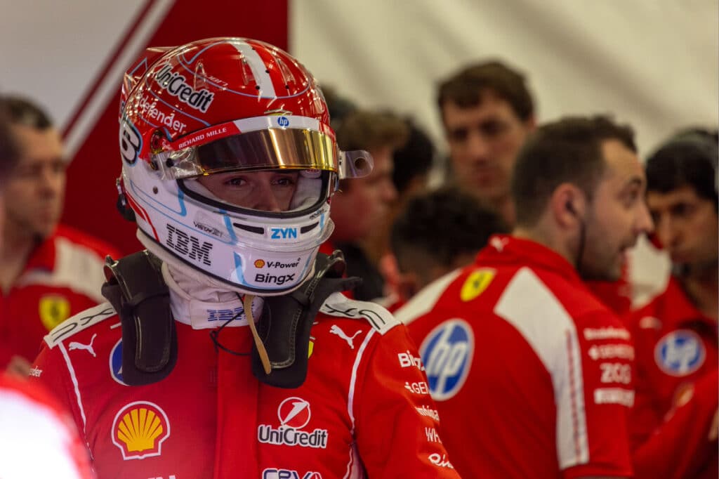 Scuderia Ferrari driver Charles Leclerc in the garage during 2026 pre-season testing, looking focused ahead of a session.