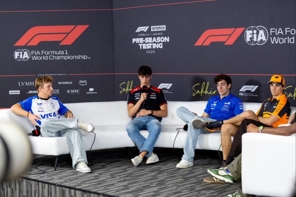 Liam Lawson, Oliver Bearman, Franco Colapinto, and Oscar Piastri participating in an FIA press conference at the 2026 Bahrain pre-season test.