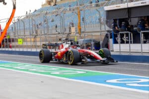 Charles Leclerc driving the Ferrari SF-26 past the pit lane during 2026 Formula 1 pre-season testing at Bahrain International Circuit.