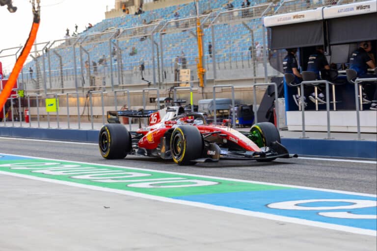 Charles Leclerc driving the Ferrari SF-26 past the pit lane during 2026 Formula 1 pre-season testing at Bahrain International Circuit.