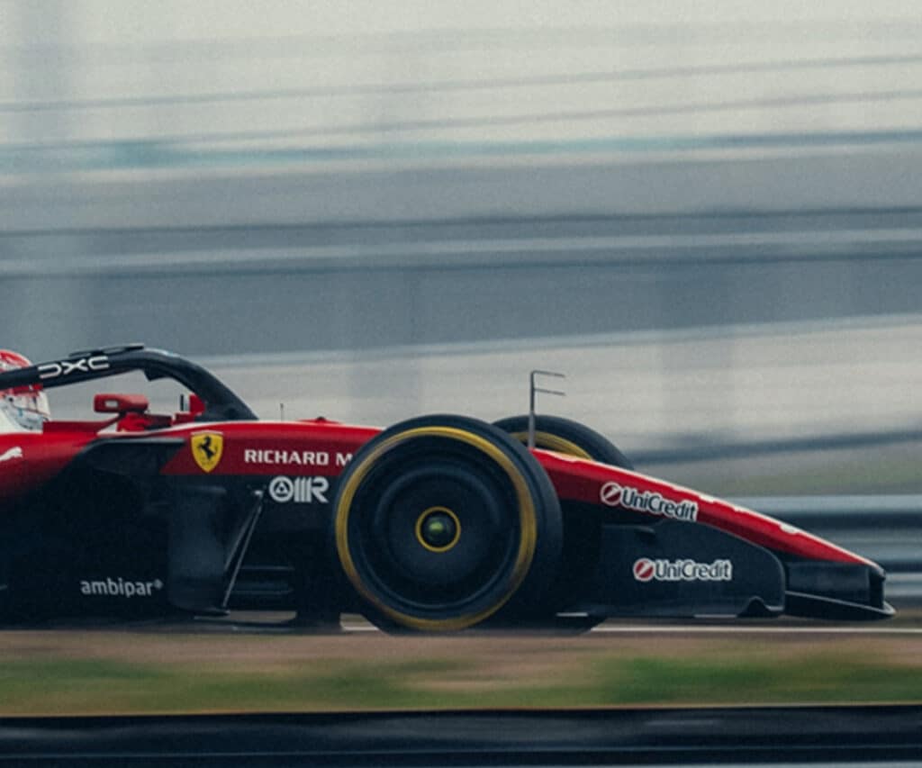 Side profile of the Scuderia Ferrari SF-26 in high-speed motion during pre-season testing, highlighting its aggressive aerodynamic concept.