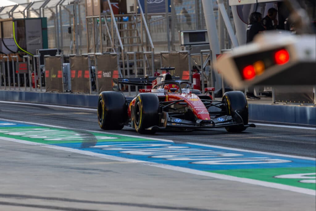 A side-profile action shot of the Ferrari SF-26 showcasing its 2026 aerodynamic package at high speed.