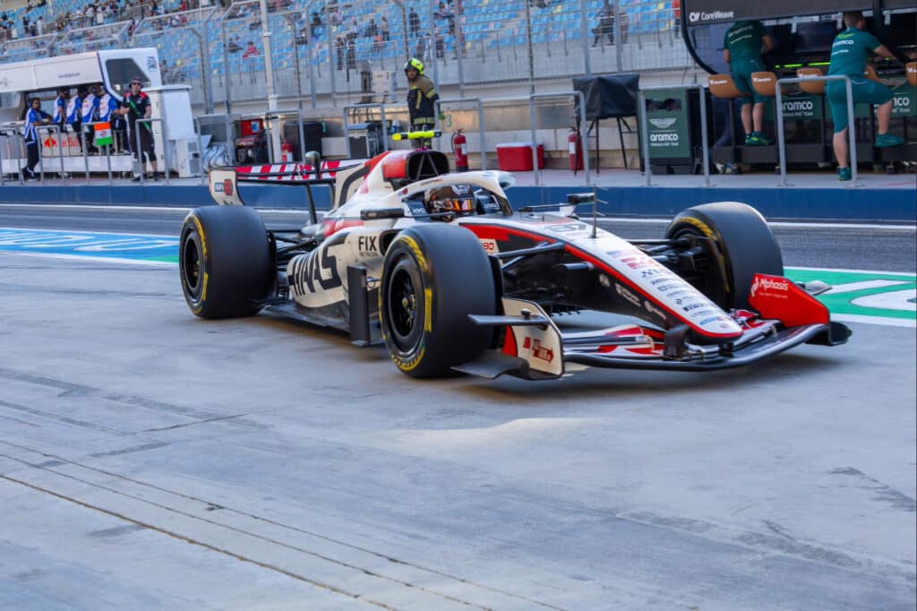 Esteban Ocon driving the Haas VF-26 out of the pits during technical data collection at the 2026 Bahrain pre-season test.