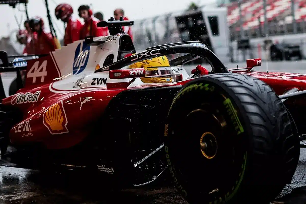 Lewis Hamilton in the red and white Ferrari SF-26 during the 2026 F1 shakedown in Barcelona on a wet track.