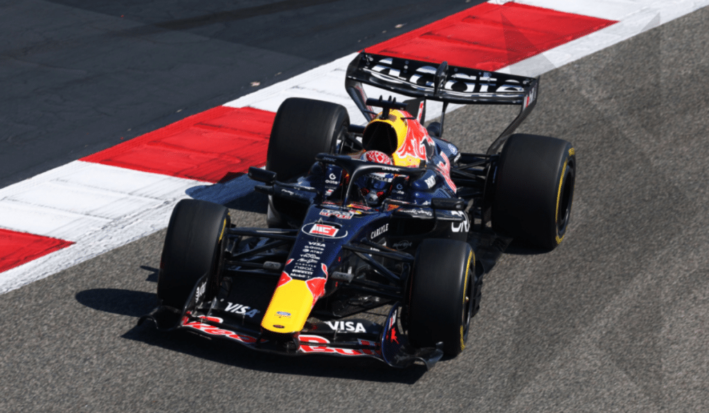 Max Verstappen driving the Red Bull Racing car during pre-season testing at the Bahrain International Circuit, showing the car's aerodynamic detail on track.
