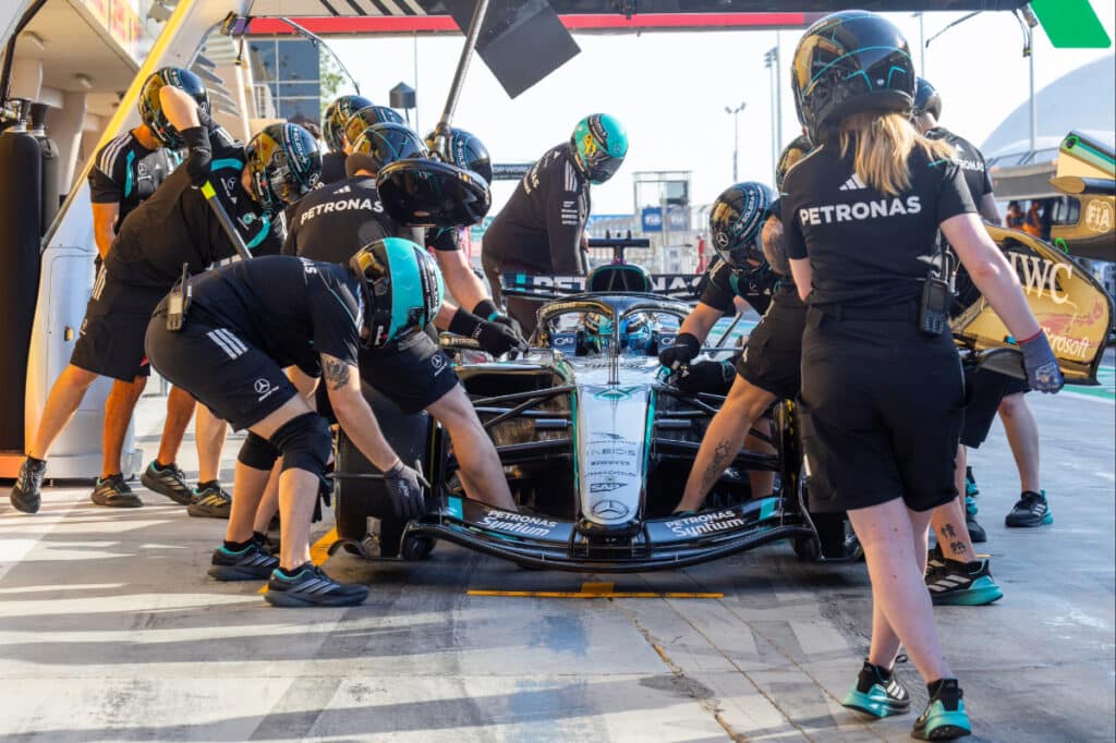A technical view of the Mercedes W17 being prepared by mechanics in the garage, showcasing the team's methodical approach to the 2026 regulations.