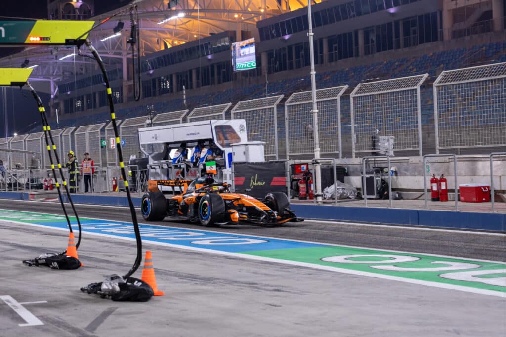Oscar Piastri driving the McLaren MCL40 under floodlights during the evening session of Day 4 pre-season testing at the Bahrain International Circuit.