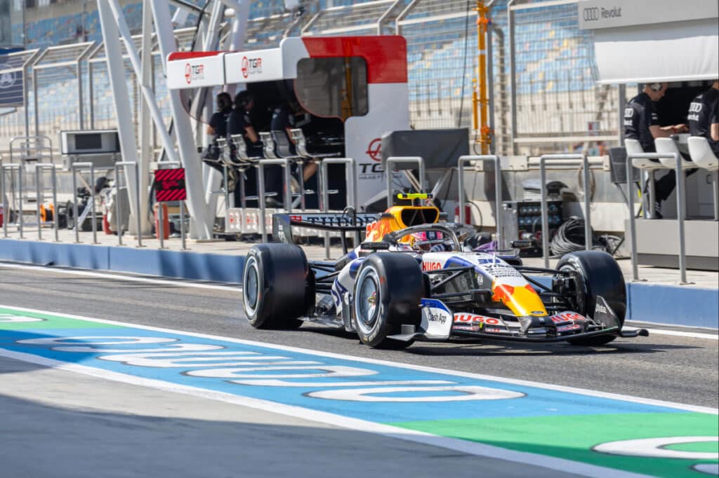 The 2026 Racing Bulls F1 car driving past the pit lane during pre-season testing at Bahrain International Circuit.