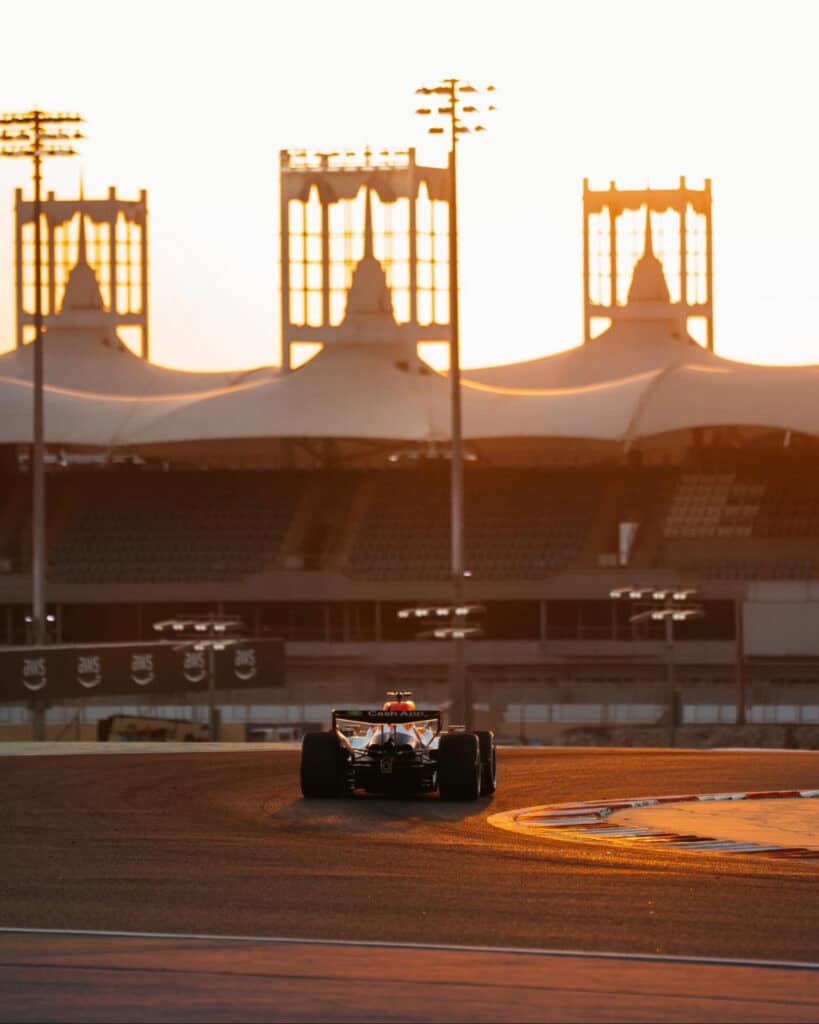 A Racing Bulls F1 car performing long-run race simulations during the sunset session of 2026 Bahrain testing.