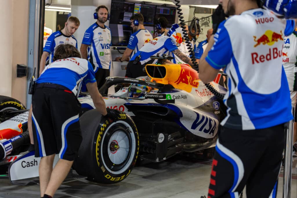 Racing Bulls F1 Team mechanics working on the car in the Bahrain garage, highlighting the team's independent operational setup.