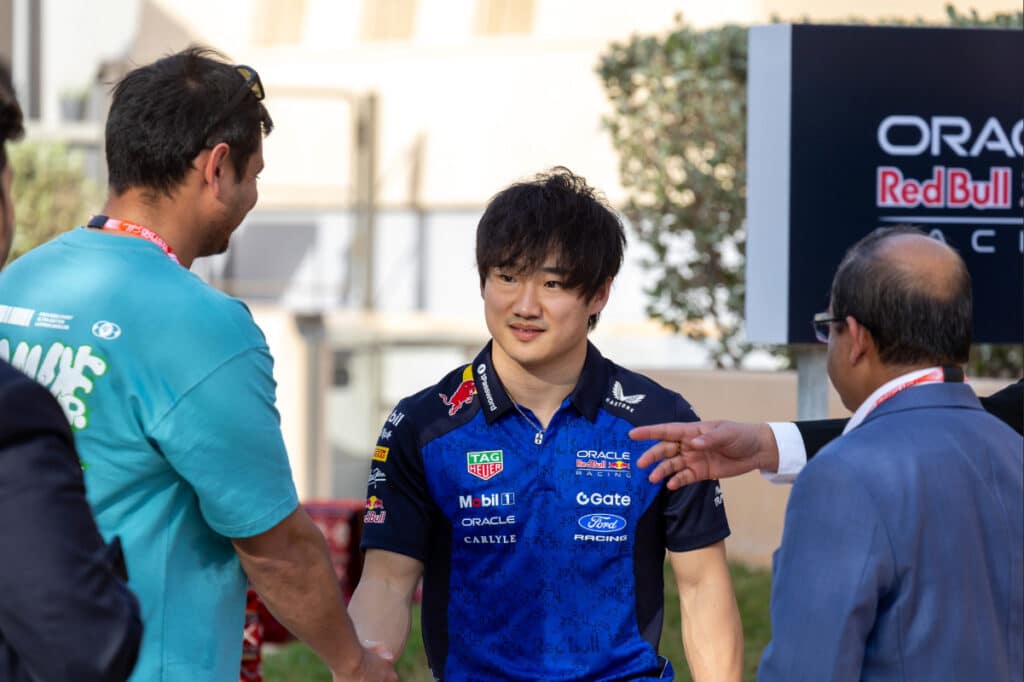 Yuki Tsunoda wearing 2026 Red Bull Racing team kit in the paddock during Day 4 of Bahrain F1 testing, where he serves as the official reserve driver.