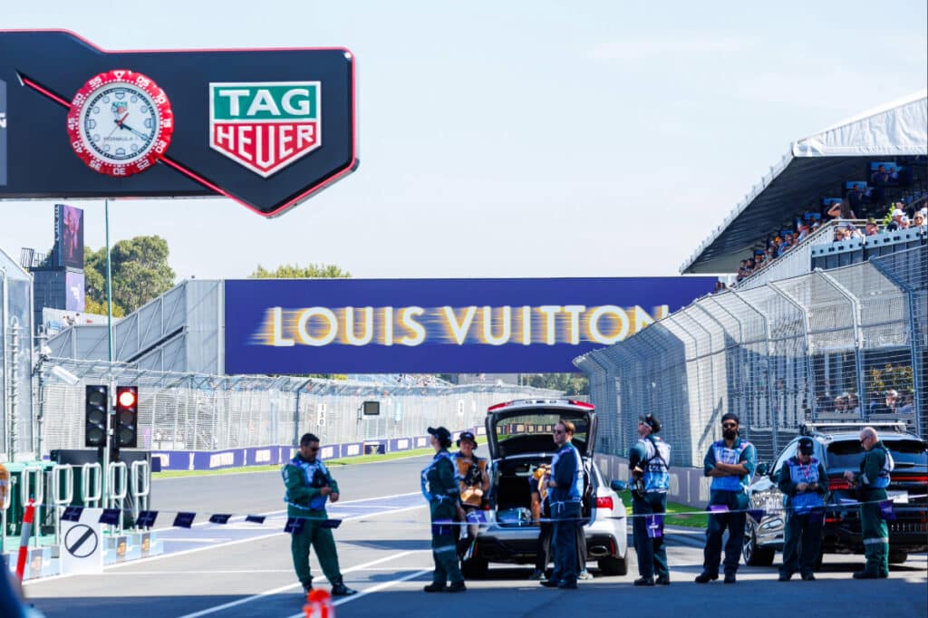 Marshals and safety vehicles clearing the Albert Park track ahead of the 2026 Australian Grand Prix race start.