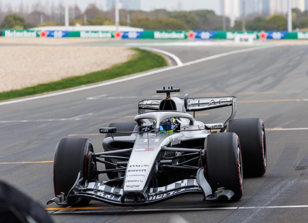 The Cadillac F1 car racing at the 2026 Chinese Grand Prix, demonstrating a stable performance during the team's debut season in Formula 1.