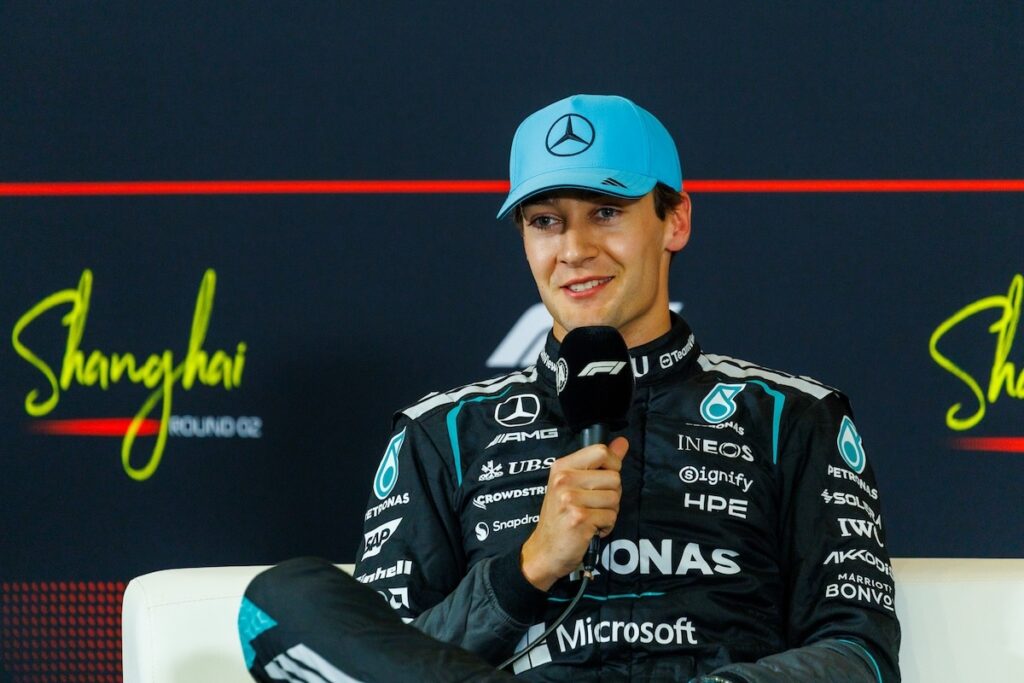 A composed George Russell speaking at the official FIA press conference following the 2026 Chinese Grand Prix qualifying session.