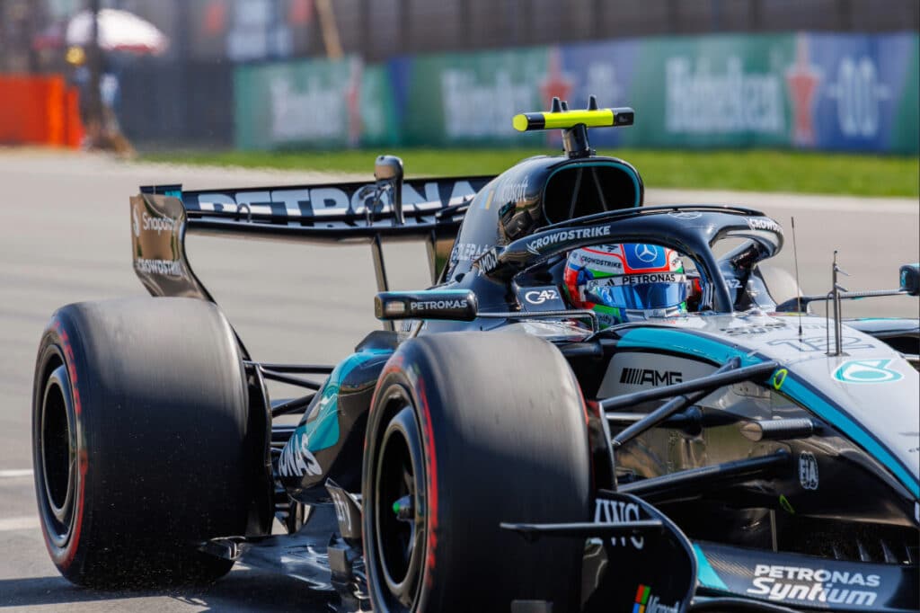 Kimi Antonelli driving his Mercedes-AMG F1 car at the 2026 Chinese Grand Prix in Shanghai, wearing his signature blue and Italian flag-themed helmet while securing his first Formula 1 victory.