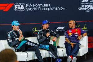 Kimi Antonelli speaking at the 2026 Chinese Grand Prix press conference alongside George Russell and Lewis Hamilton after becoming the youngest polesitter in F1 history.