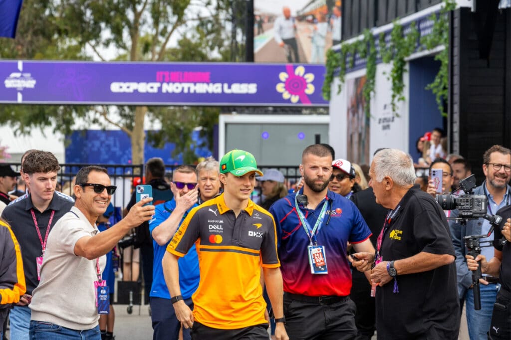 McLaren driver Oscar Piastri walking through the fan-filled Melbourne Walk during the 2026 Australian Grand Prix.