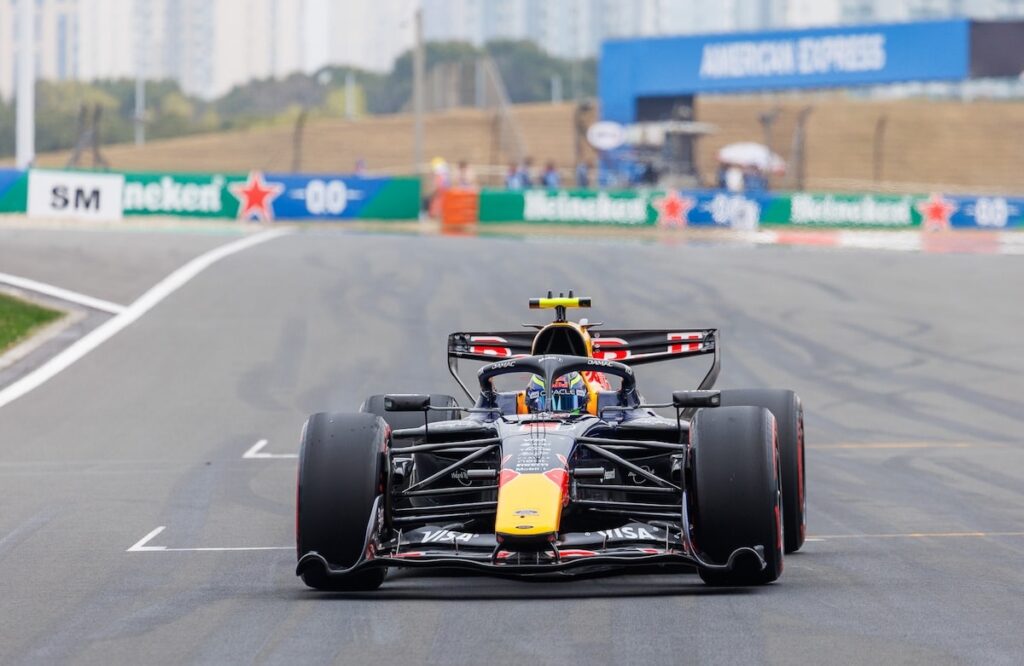 A Red Bull Formula 1 car navigating a turn during the 2026 Chinese Grand Prix, illustrating the intense competition and narrow margins in the midfield.